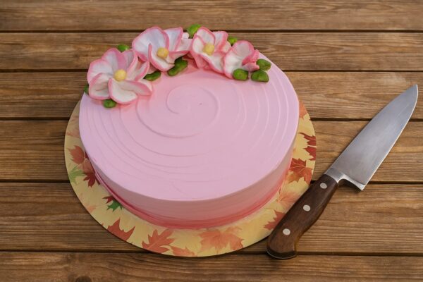 Strawberry Cake Decorated with white and pink icing flowers